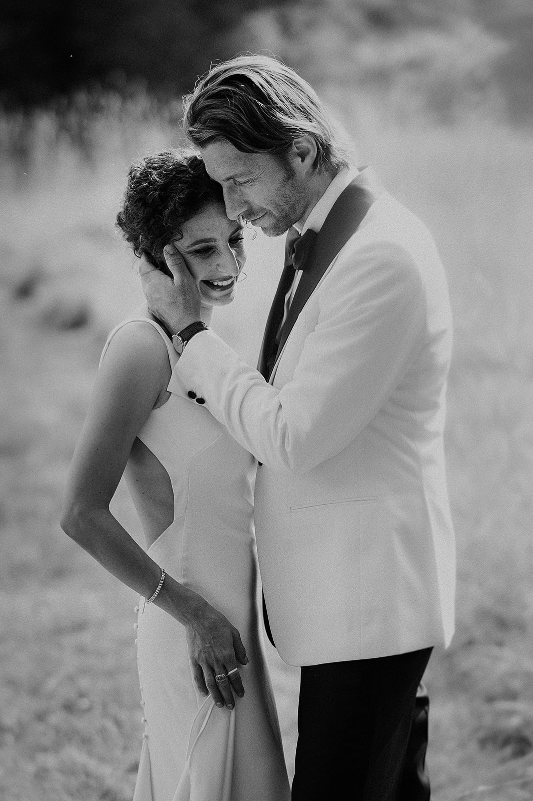 bride and groom at Babbighton House in somerset getting close and hugging in black and white