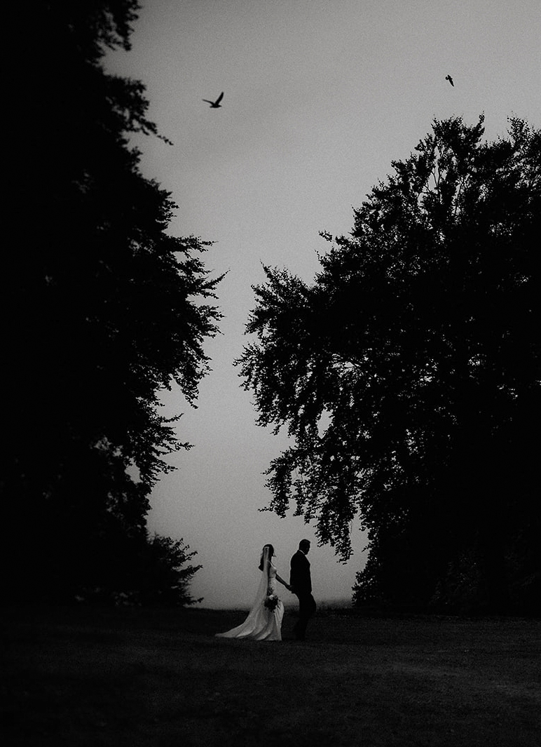 bride and grrom walking at dusk at Euridge manor