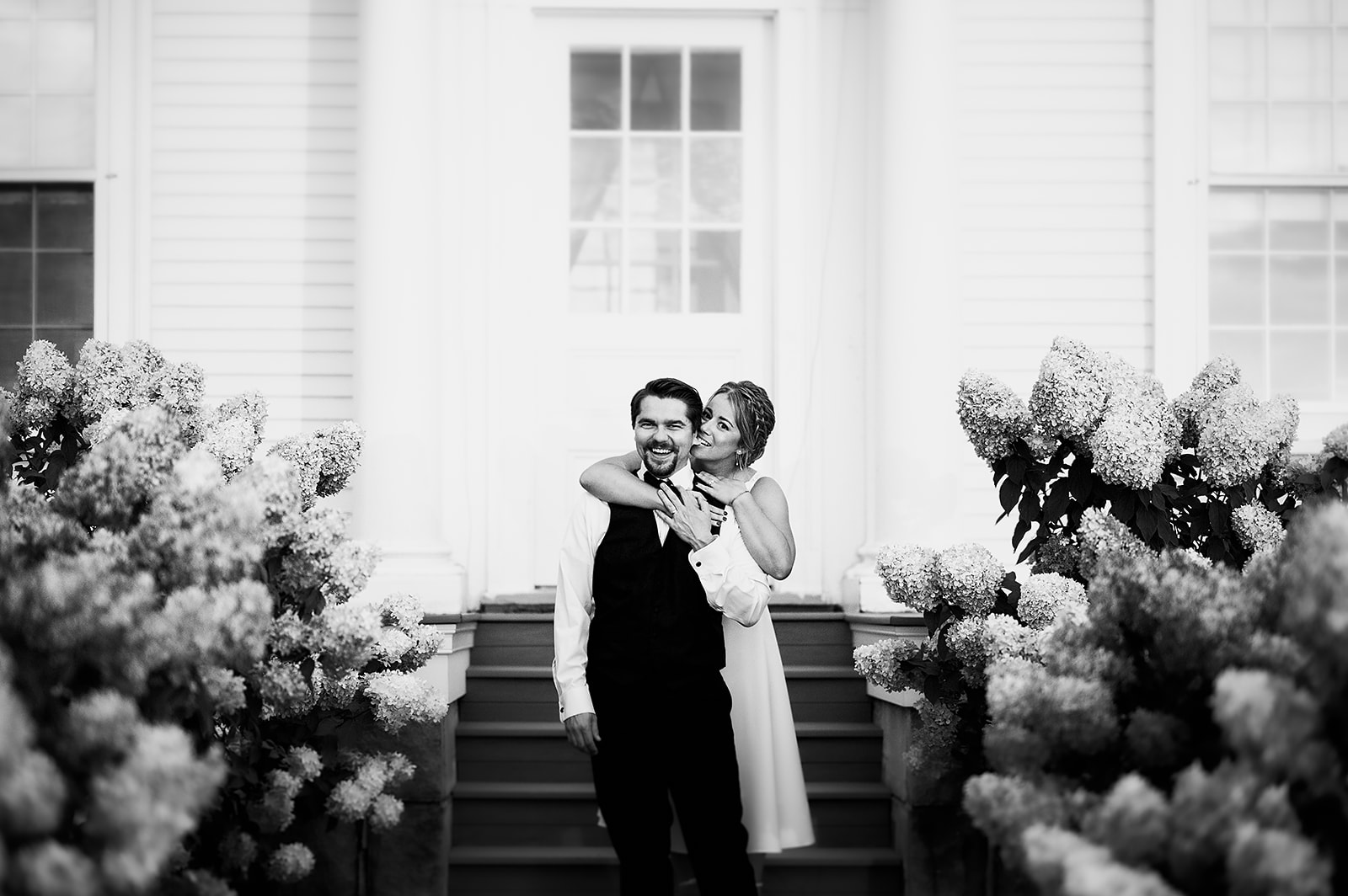 bride and groom playing about at the inn at East Burke in Vermont